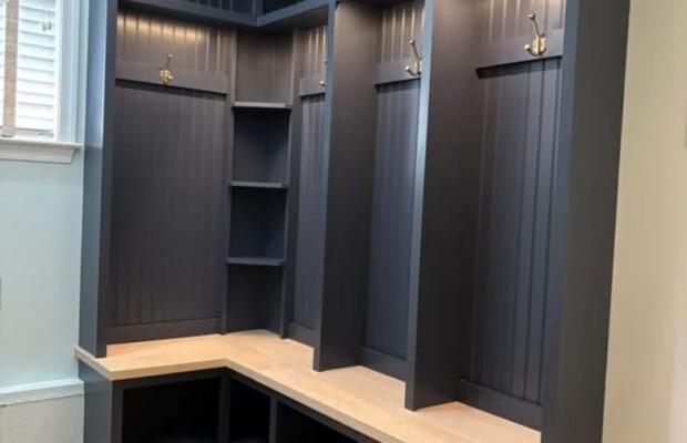 Navy mudroom lockers with a beadboard back, wood bench seat and open cubbies