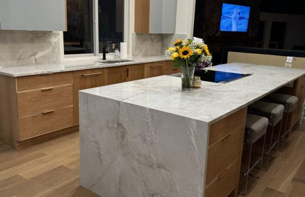 Two-tone kitchen with white uppers, natural oak bases and a waterfall island