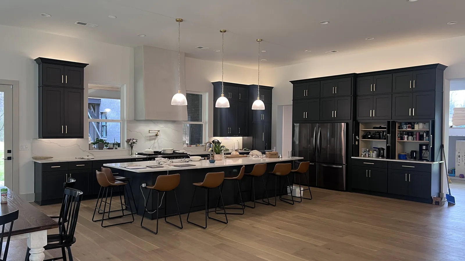 Charcoal shaker kitchen in Atlanta with a long island, bar seating and three pendant lights