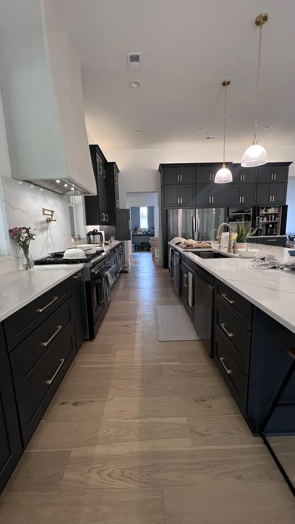 View along the charcoal shaker kitchen toward the island and pendants