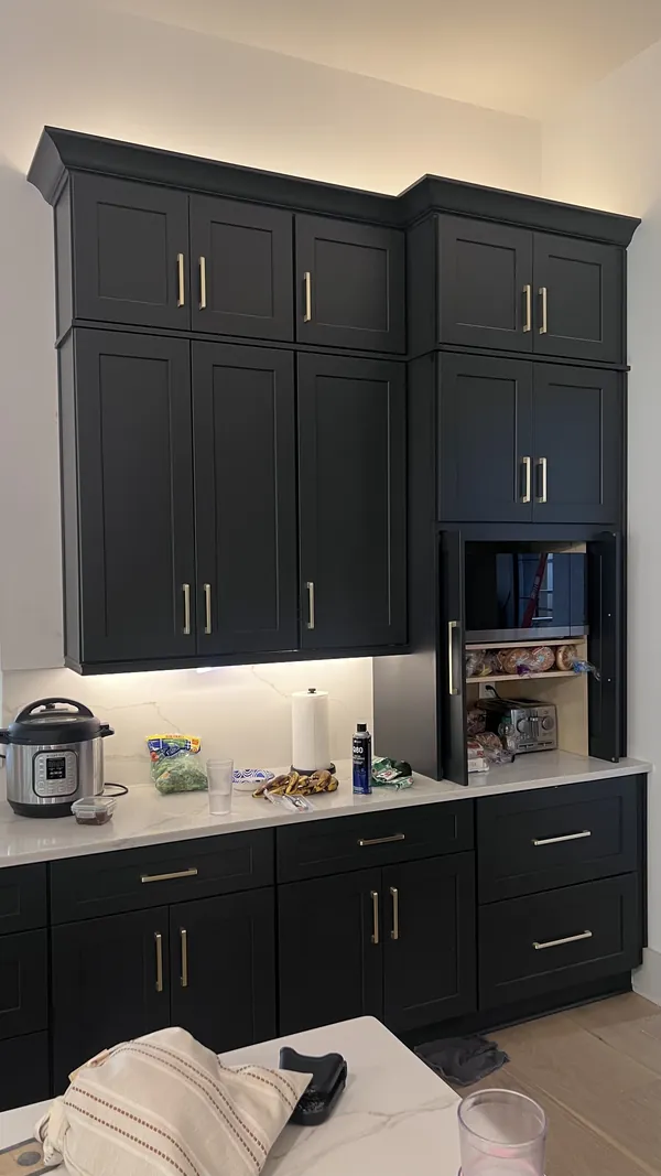 Charcoal shaker tall cabinets with a microwave opening above the counter